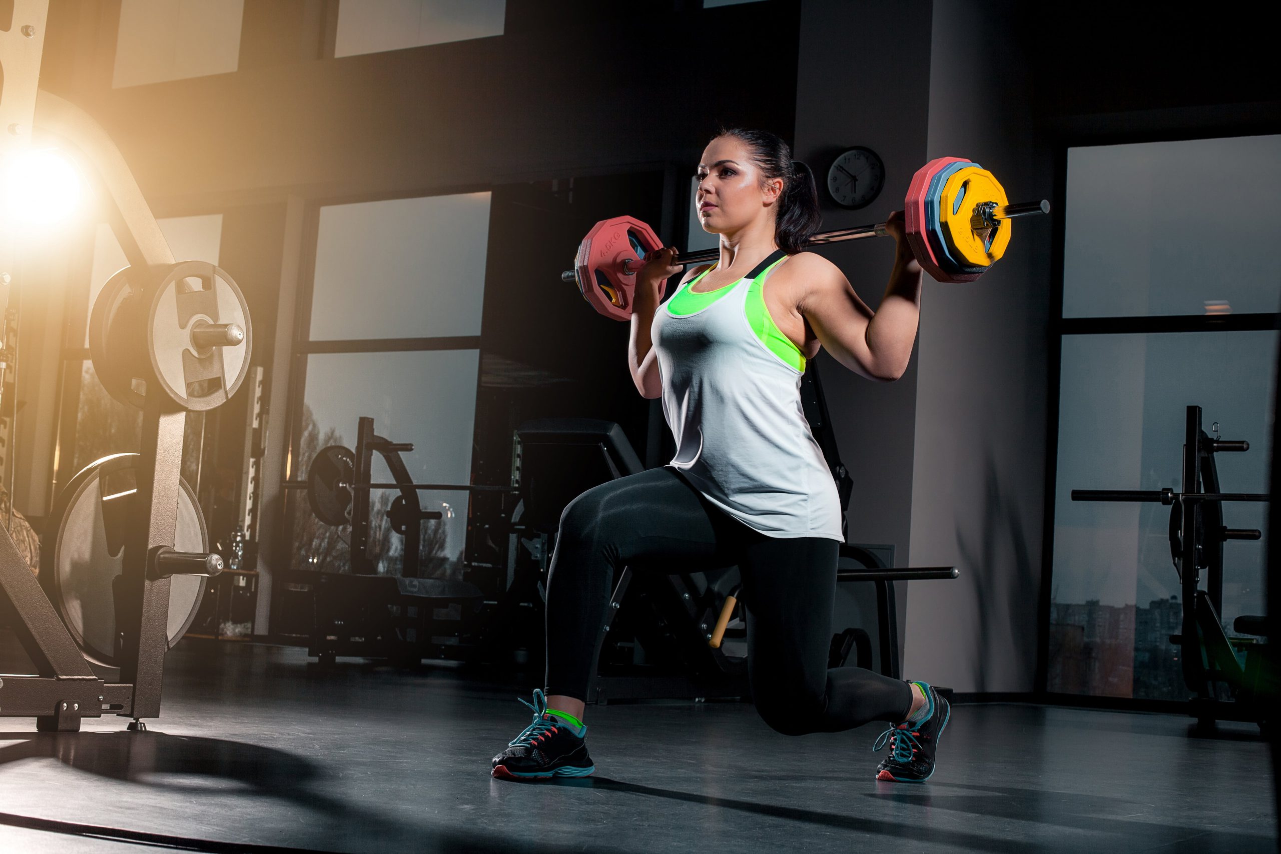 fit-young-woman-lifting-barbells-looking-focused-working-out-gym-min
